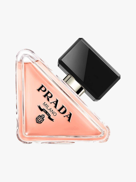 Prada Paradoxe Eau de Parfum triangle bottle of peach perfume on its side with black cap on light gray background